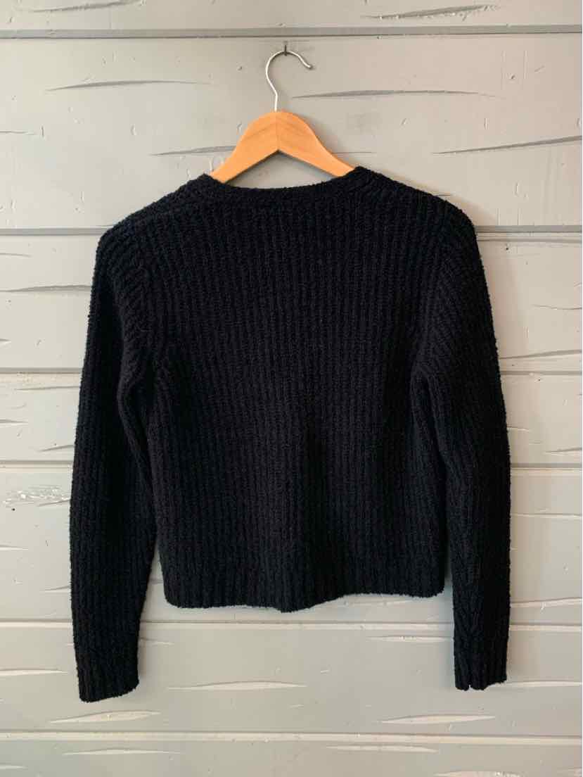 Black ribbed knit sweater with long sleeves and crew neckline, size XS.