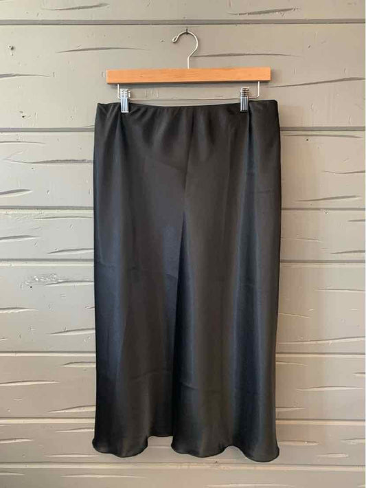 Black midi skirt with slight flare, smooth fabric, elastic waistband, size XL.