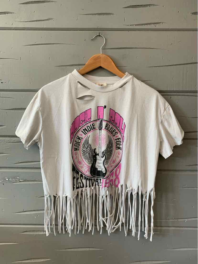 White cropped t-shirt with black and pink graphic, distressed fringe hem, short sleeves.