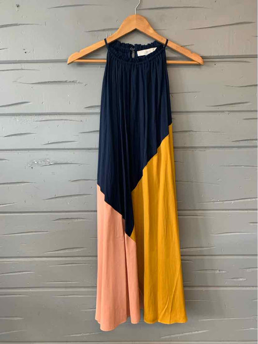 Sleeveless color block maxi dress with navy, mustard yellow, and blush pink panels on a wooden hanger.