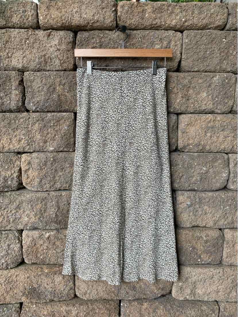 Tan midi skirt with subtle cheetah print and flowing silhouette in size XS.
