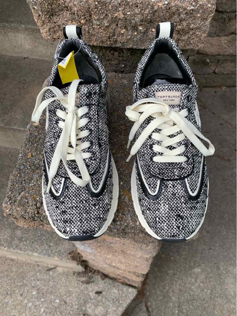 Black and white tweed sneakers with white laces, rounded toe, and black padded collar, size 10.