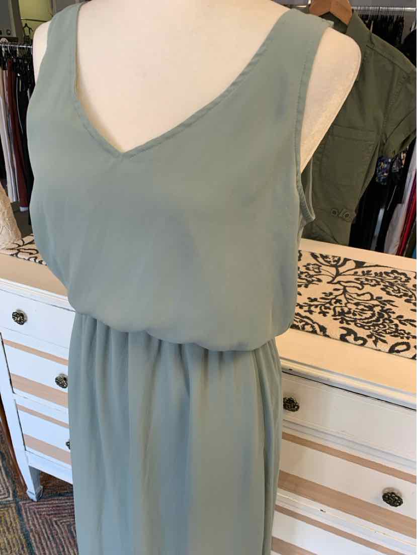 Olive green sleeveless dress with V-neck and gathered waist detailing.