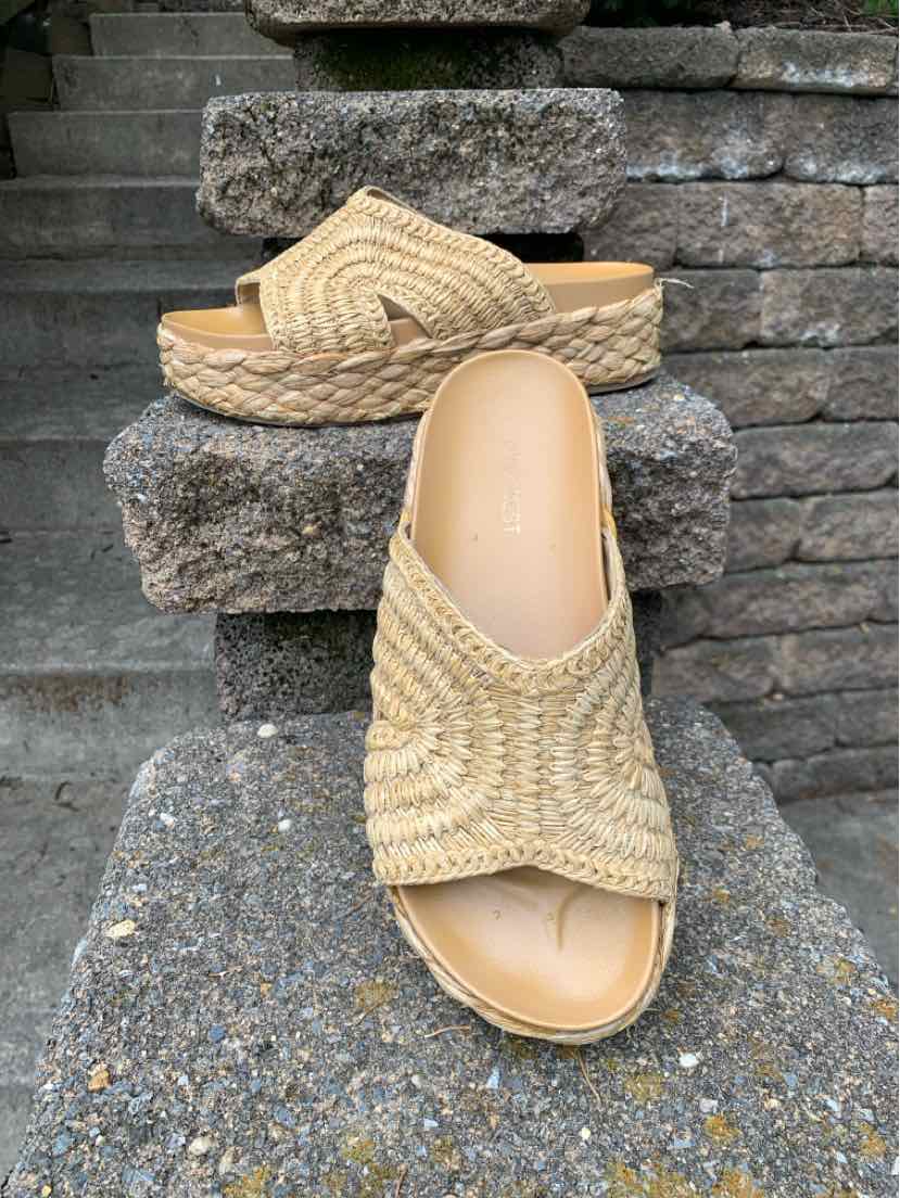 Beige woven open-toe sandal with a peep toe and a low platform sole.