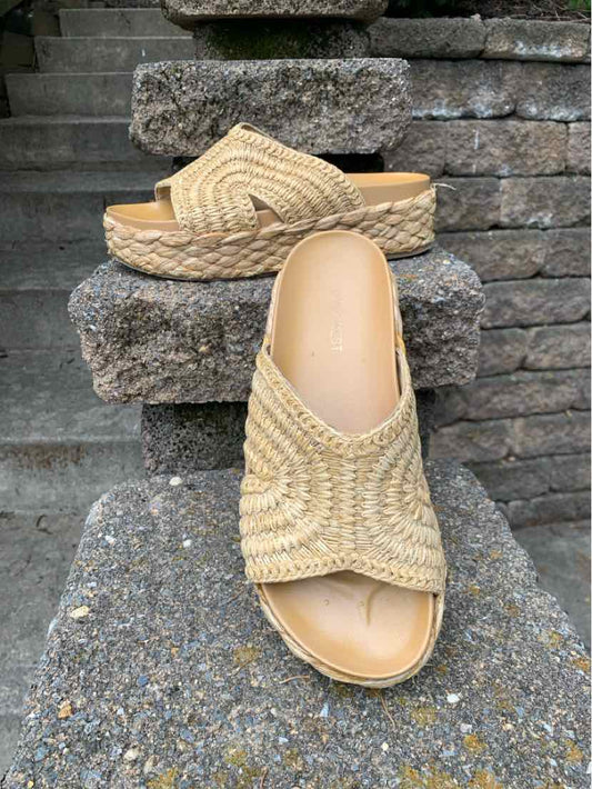 Beige woven open-toe sandal with a peep toe and a low platform sole.