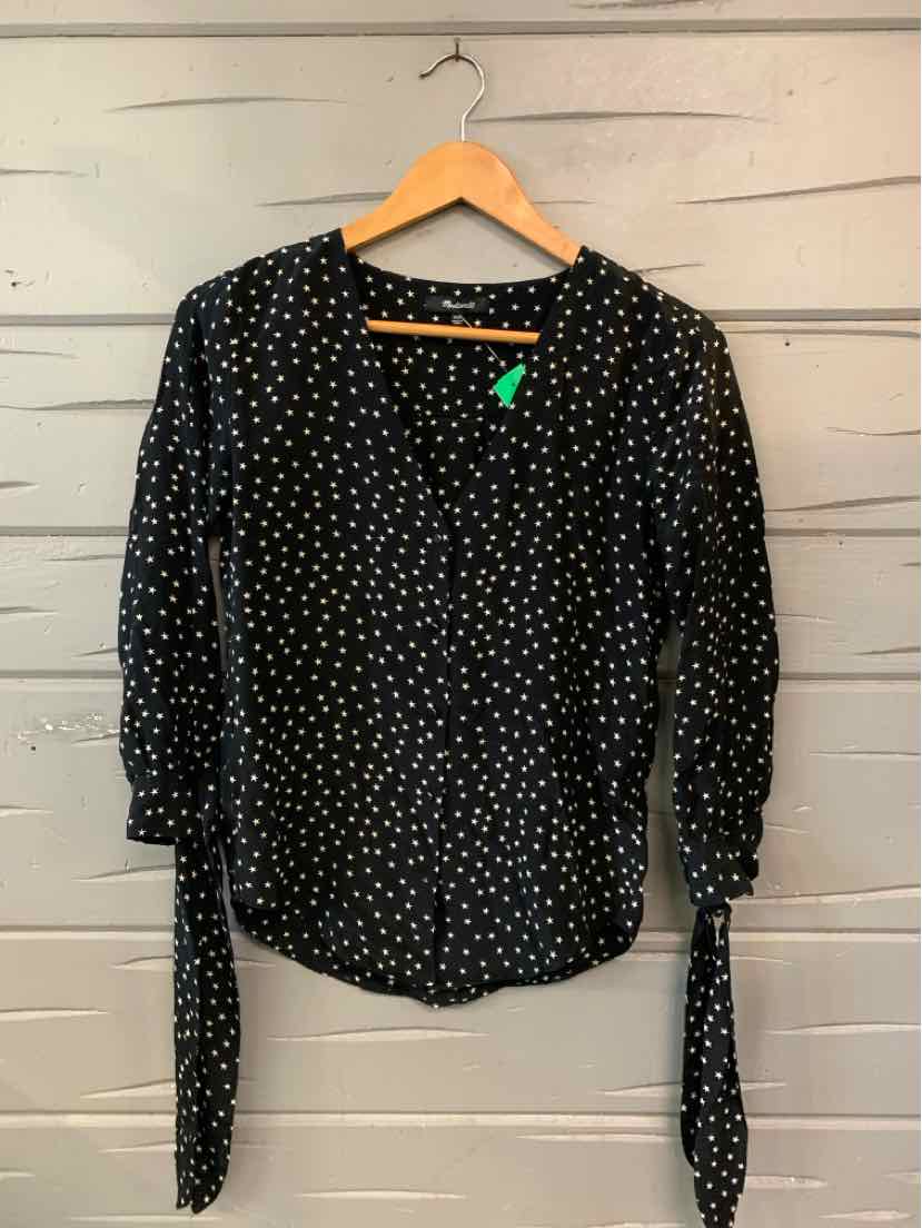 Black long-sleeve blouse with white star print, round neckline, and tie cuffs on sleeves.