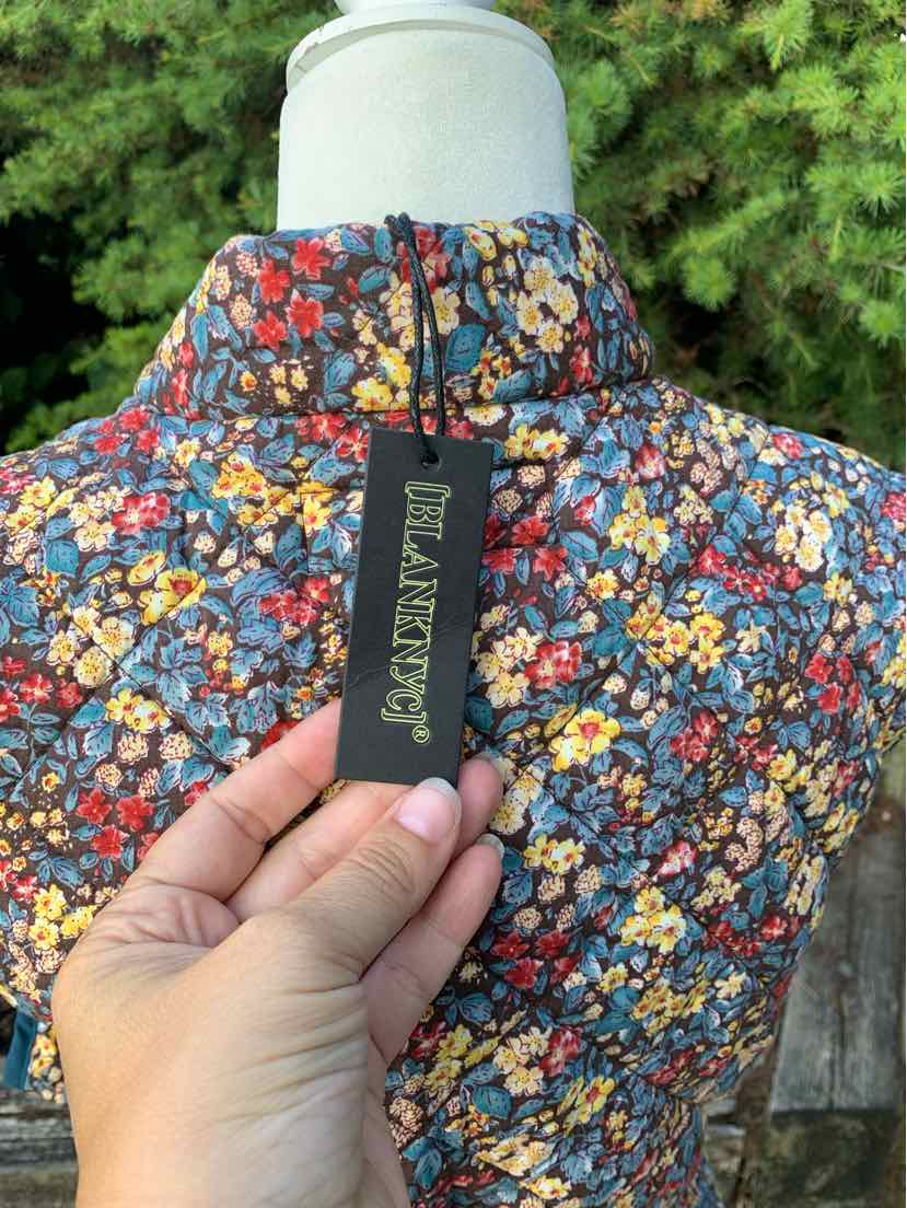 Floral-print jacket in multi colors with high collar and zipper, lightweight fabric.
