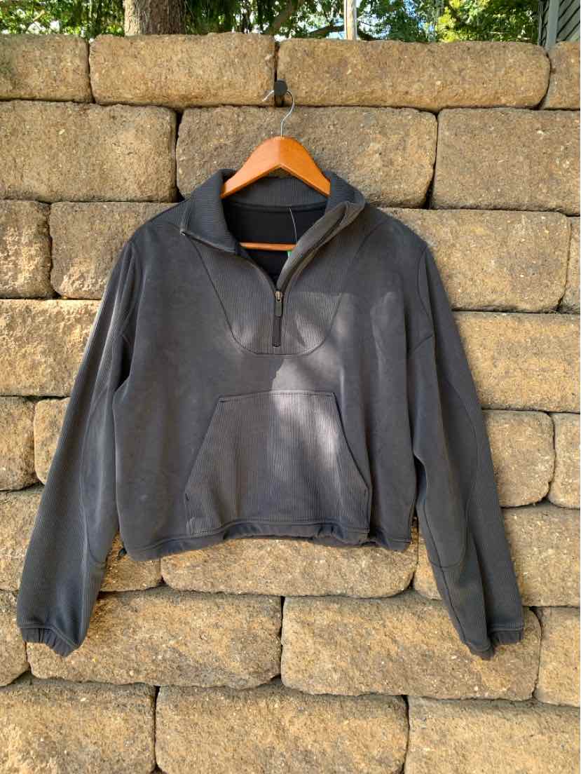 Gray half-zip pullover with long sleeves and a high collar, relaxed fit, soft fabric.