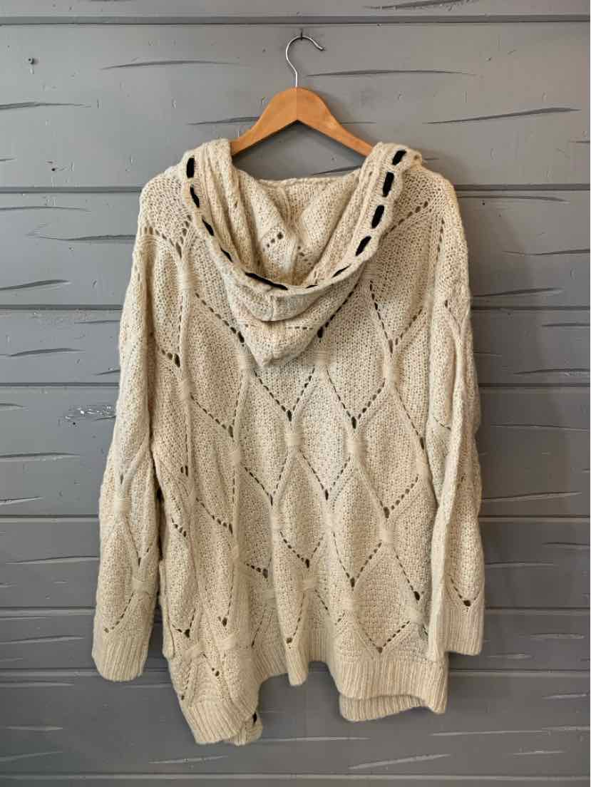 Cream knit hooded sweater with textured diamond pattern and button accents on the hood.