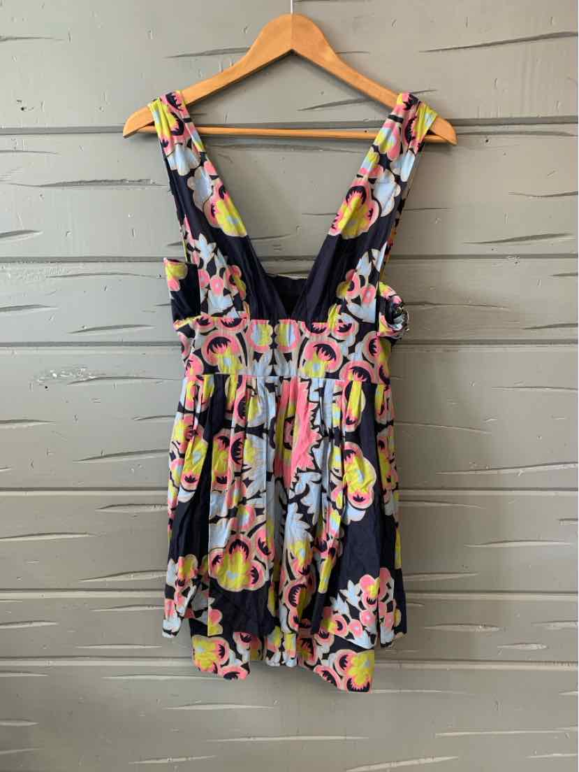 Floral sleeveless dress with deep V-neck and gathered waist in black, pink, yellow, and white colors.