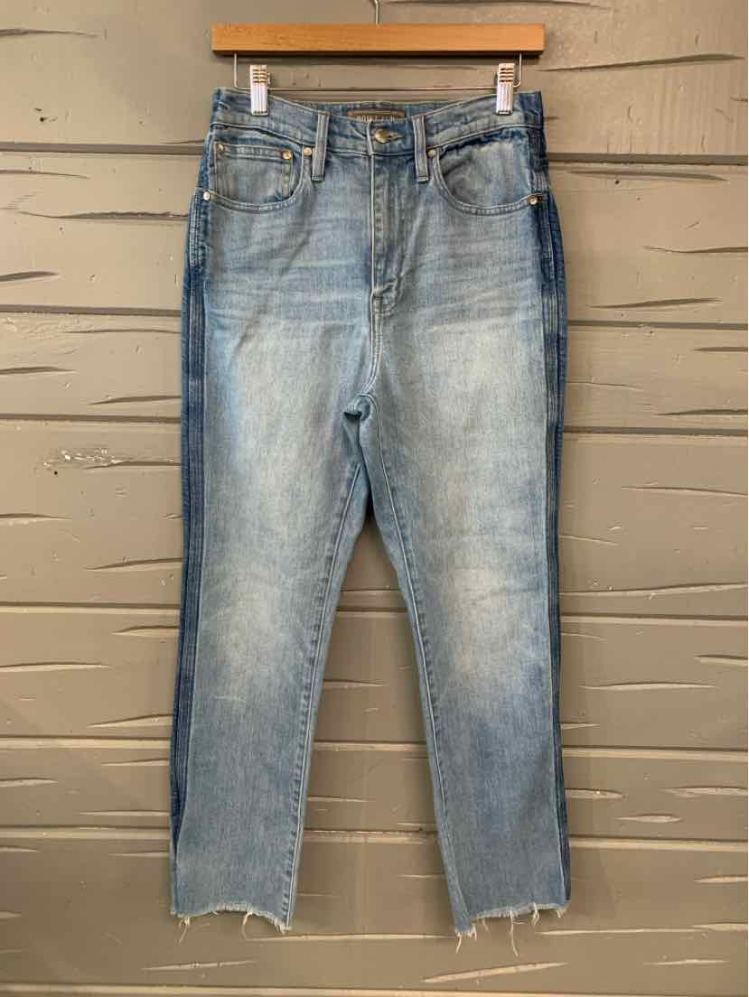 Light blue denim jeans in size 4 with a slightly faded wash and raw hem detailing.