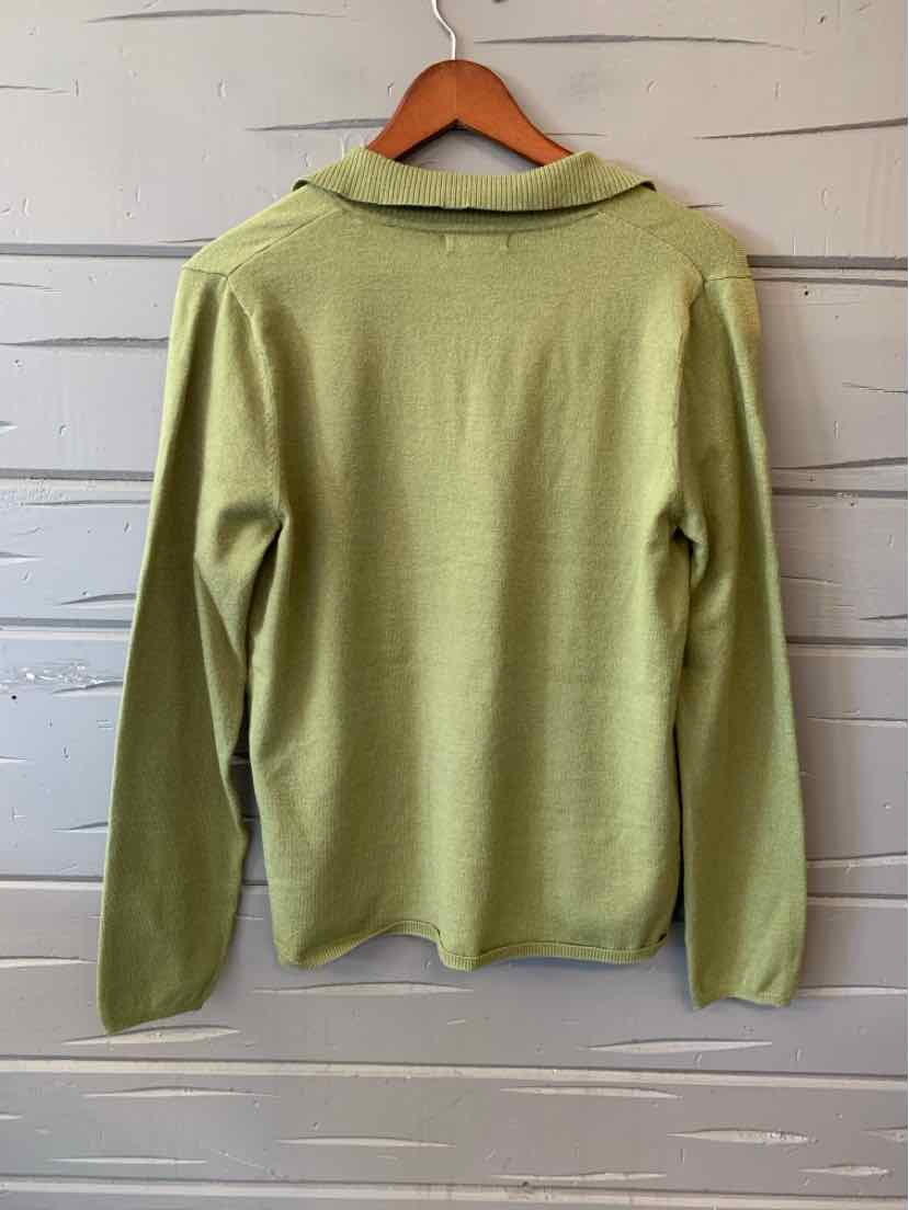 Light green long-sleeve knit sweater with a soft collar, medium size, hanging on wooden hanger.