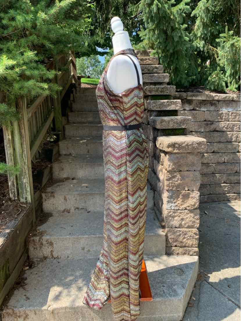 Metallic sleeveless maxi dress with zigzag pattern and side slit on mannequin outdoors.