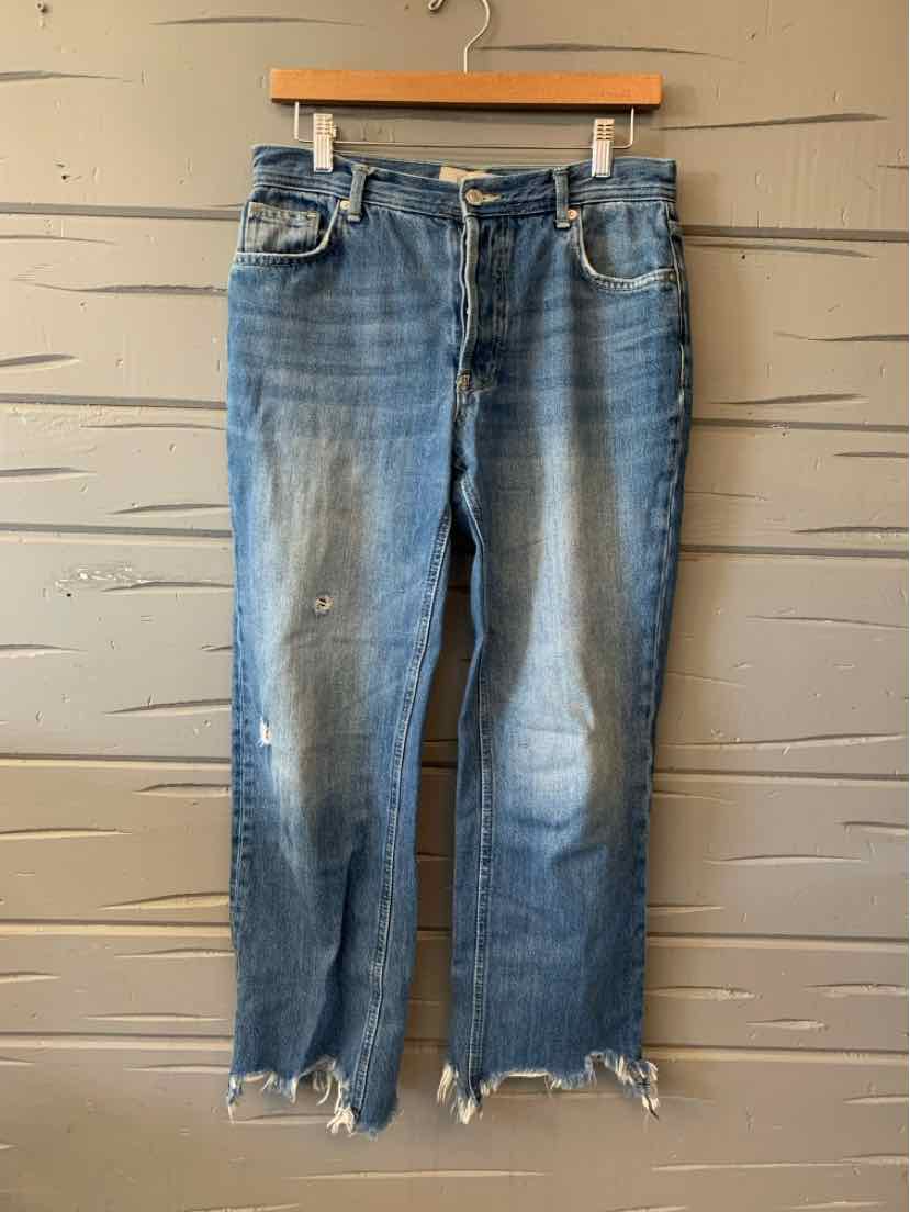 Blue denim jeans with faded details, distressed hem, and casual fit for women's activewear apparel.