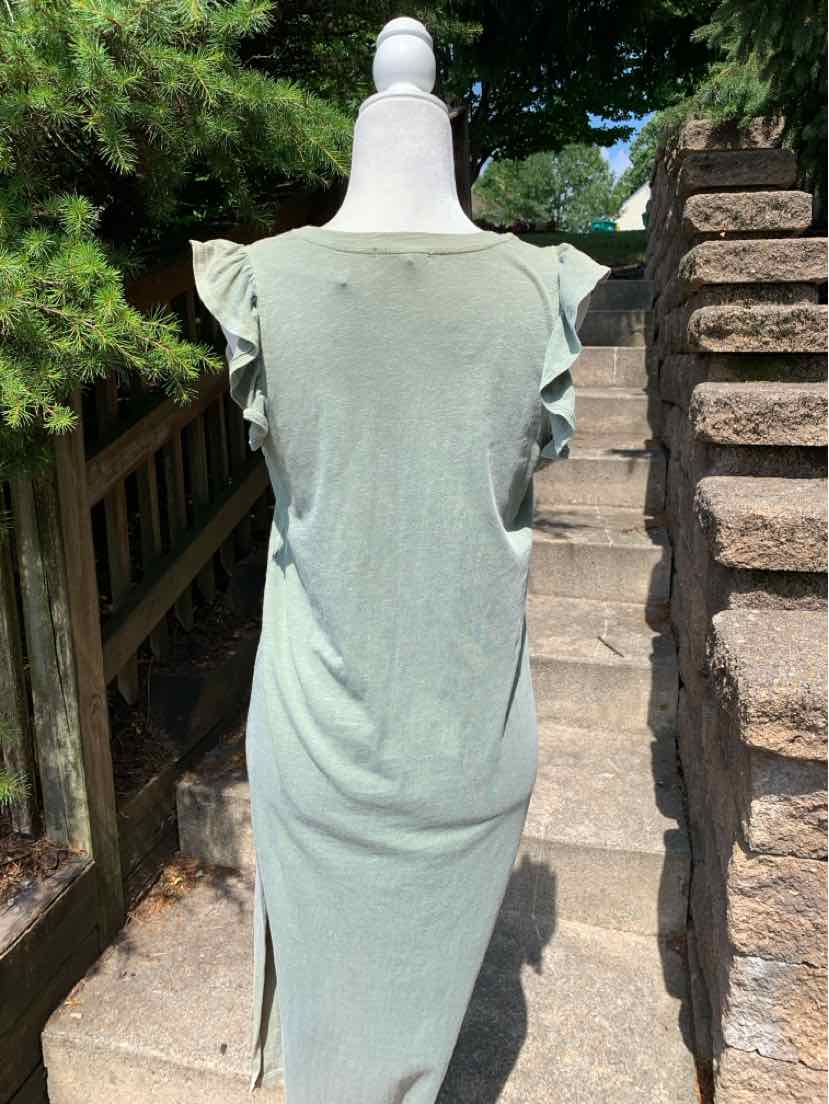Light green short-sleeve dress with ruffle details on shoulders, fitted silhouette, lightweight fabric.