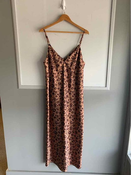 Beige slip dress with thin straps and cheetah print pattern in size XXL hanging on wooden hanger.