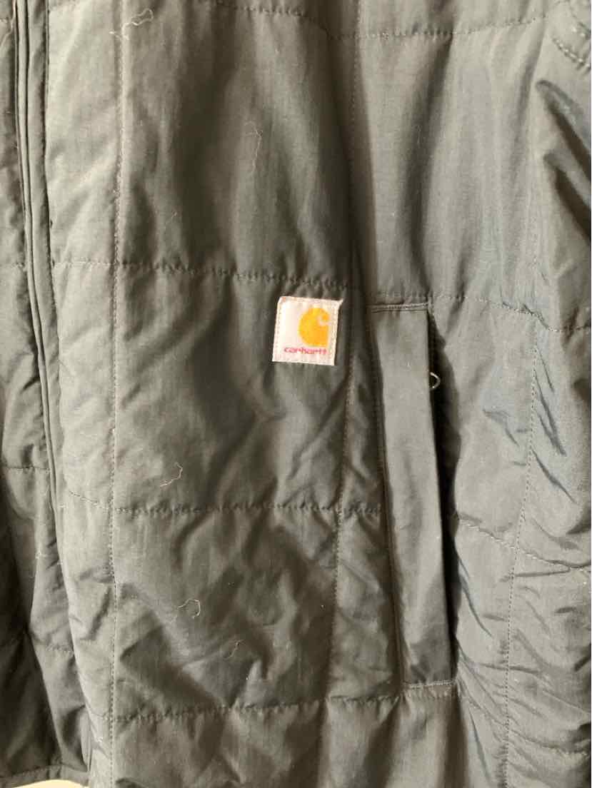 Black quilted jacket with Carhartt logo patch on chest pocket, size large.