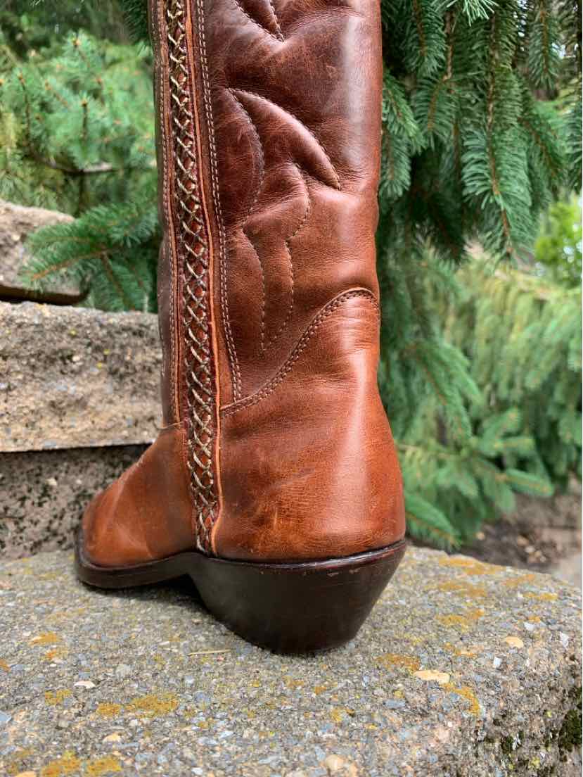 Brown leather western boot with decorative stitching and stacked heel, size 6.
