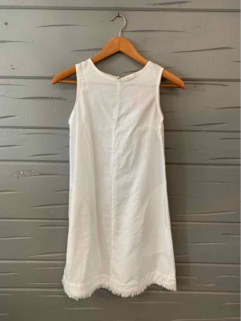 White sleeveless linen dress with scalloped hem, size 8, hanging on wooden hanger.