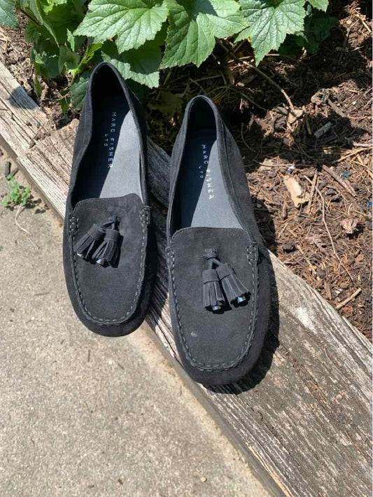 Black suede loafers with rounded toes, tassel accents, and low heels.