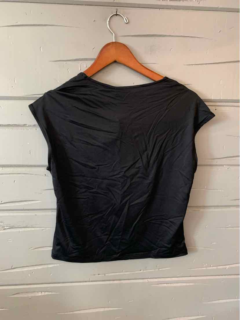 Black short-sleeve fitted top with a slight sheen, hanging on wooden hanger against white wooden background.