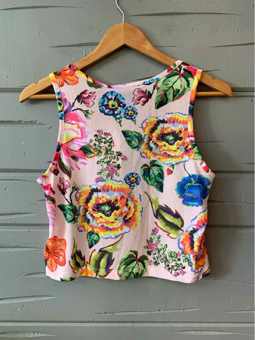 Pink sleeveless crop top with vibrant multicolored floral print and round neckline.