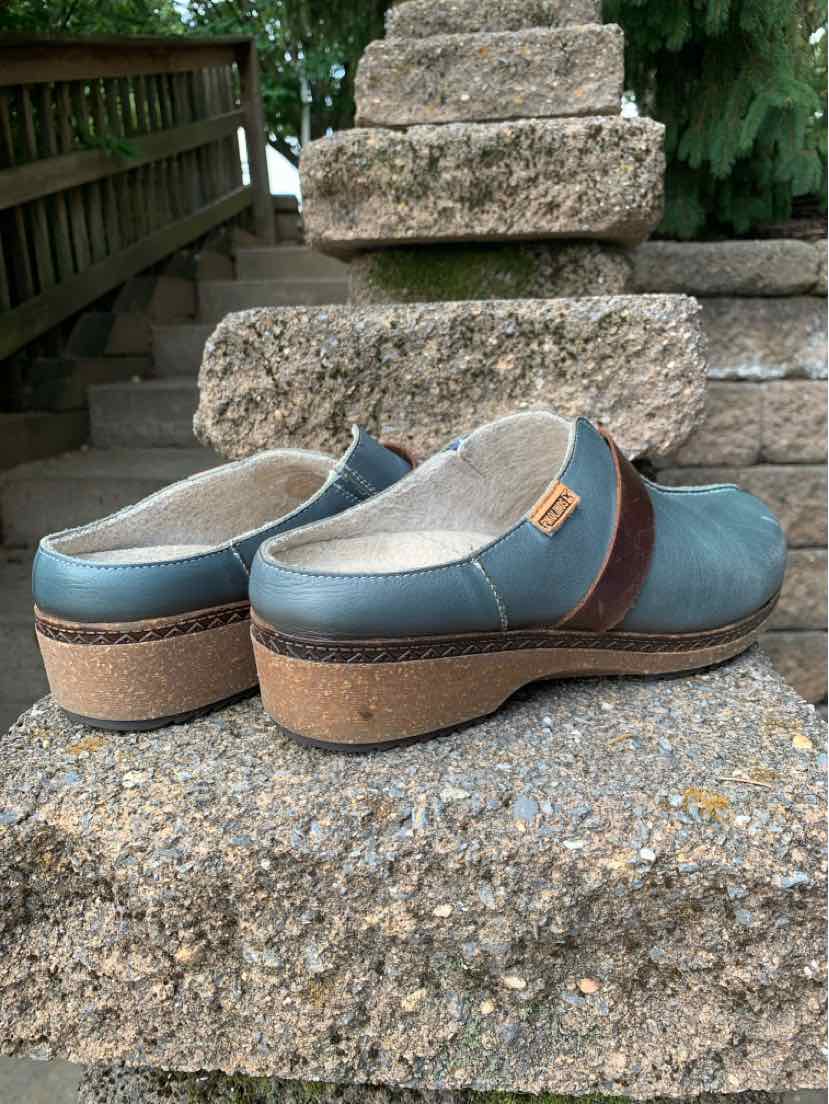 Blue leather slip-on clogs with brown accent strap and cork wedge sole, size 39.
