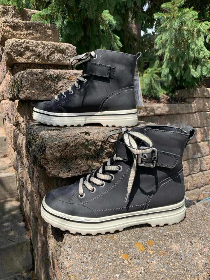 Black leather high-top boots with white thick rubber soles and silver eyelets, size 8.
