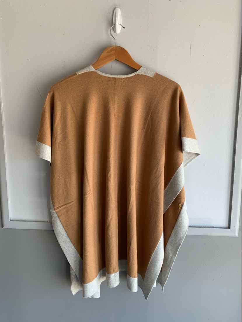 Brown and beige color-blocked loose fit short sleeve top on wooden hanger.