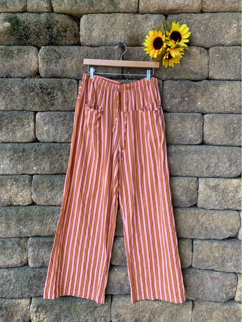 High-waisted wide-leg pants with vertical orange and white stripes, front pockets, and belt loops.