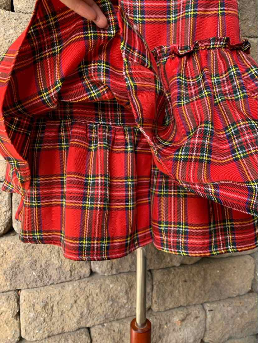 Red plaid umbrella with green and yellow stripes, ruffled fabric panels, and a slim metal shaft.