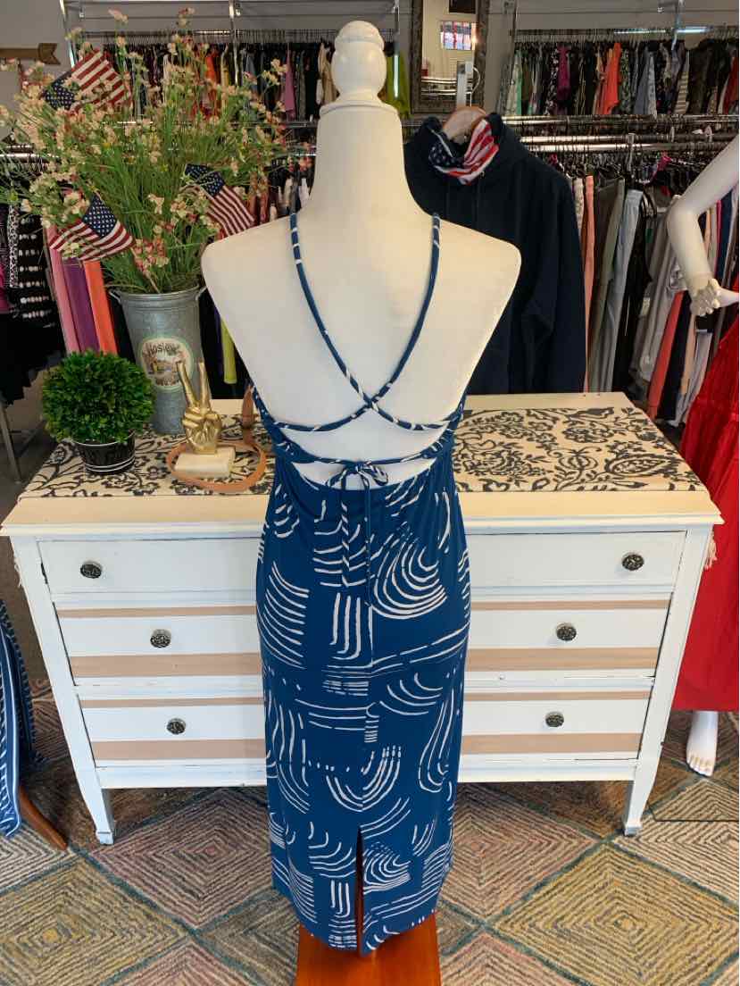 Blue sleeveless dress with white abstract pattern and crisscross back straps on mannequin.
