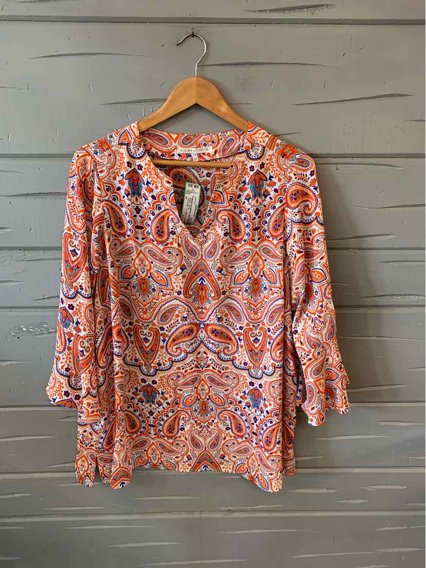 Long-sleeve paisley blouse in orange, purple, and white with gathered cuffs and a scoop neckline on a wooden hanger.