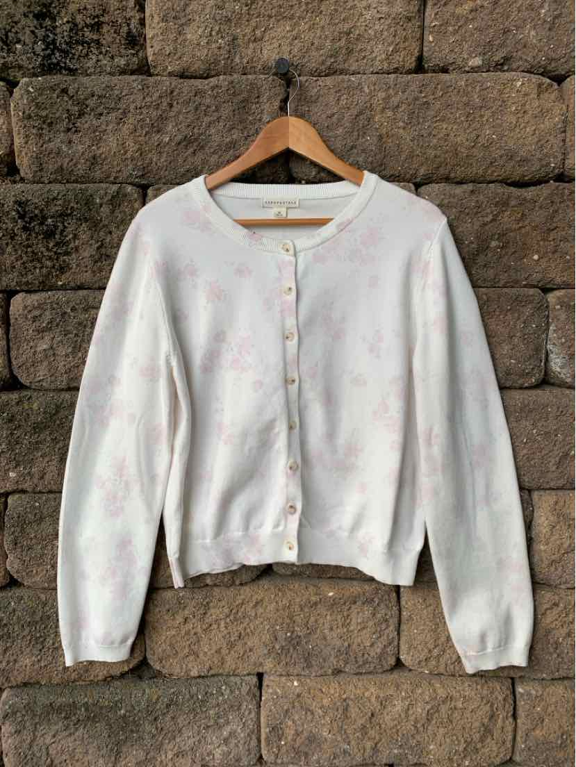 White cropped Aero "Aeropostale" cardigan with a round neckline, button front, and subtle pastel floral pattern.