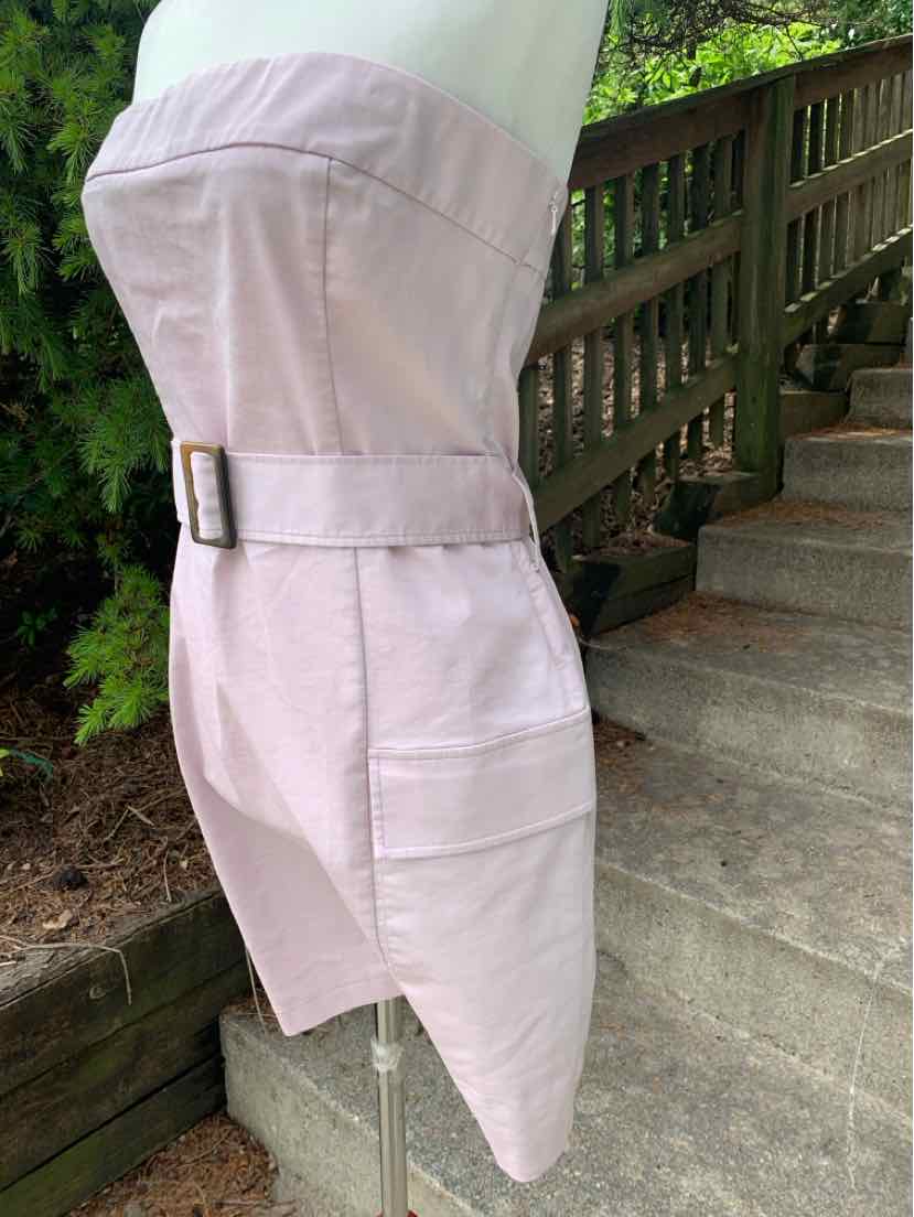 Light lavender fitted skirt with belt and side pocket, knee-length with structured fabric.