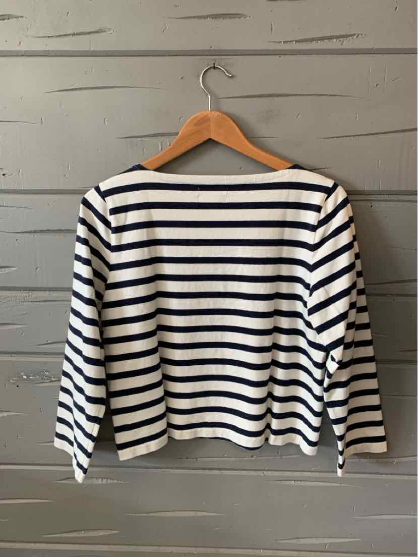 White long-sleeve shirt with navy horizontal stripes and a boat neckline hanging on a wooden hanger.