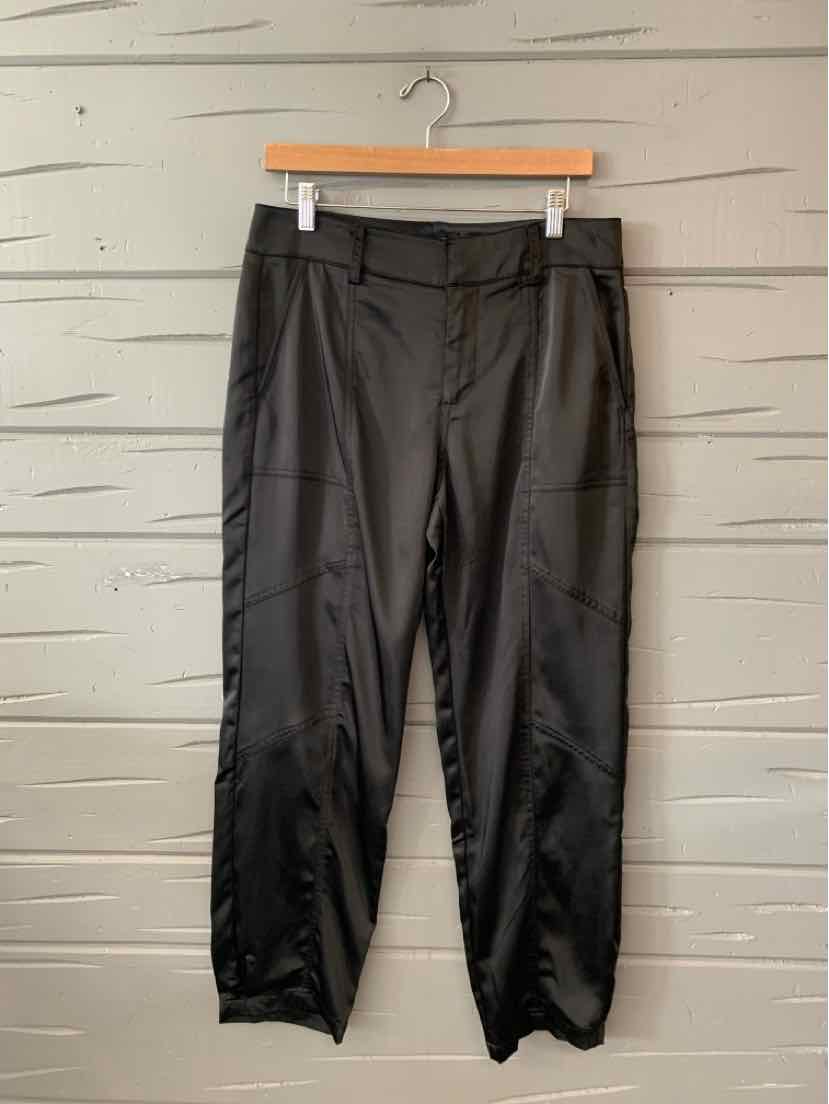 Black tapered pants with belt loops, front pockets, and elasticized cuffs in size 6.
