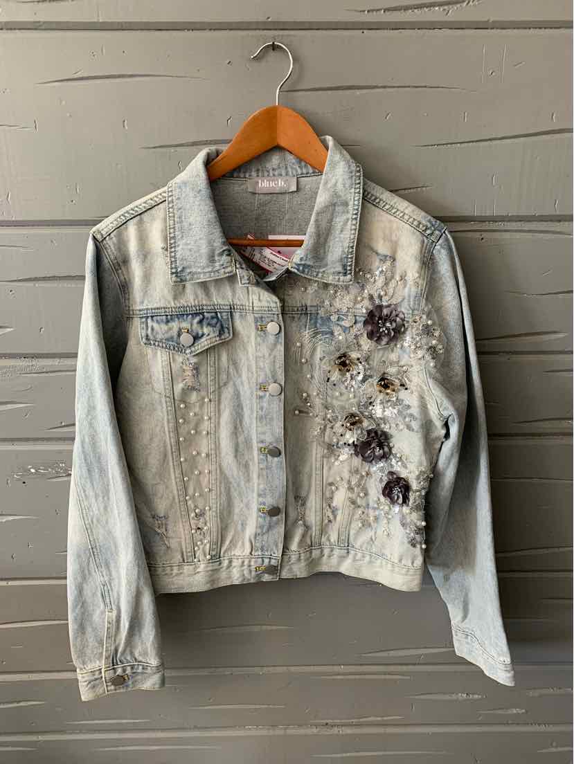 Light wash denim jacket with floral embroidery and button-front closure in large size.