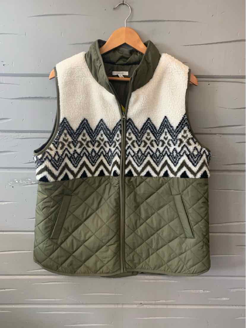 Sleeveless quilted olive green vest with white fleece top and navy blue geometric pattern across chest.