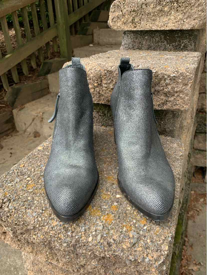 Metallic silver ankle boots with pointed toes, smooth leather, and side pull tabs.