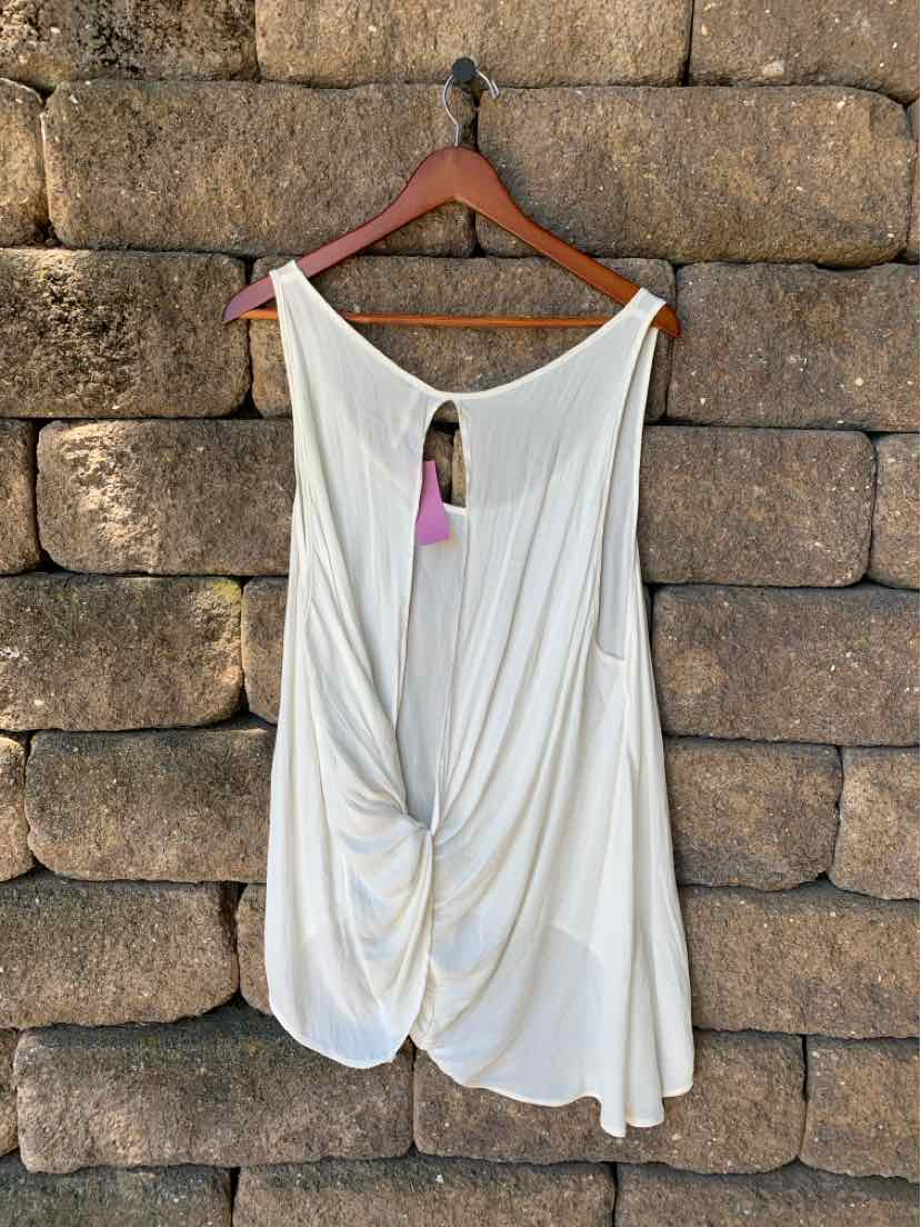 White sleeveless blouse with draped twist front and open back detail on wooden hanger.