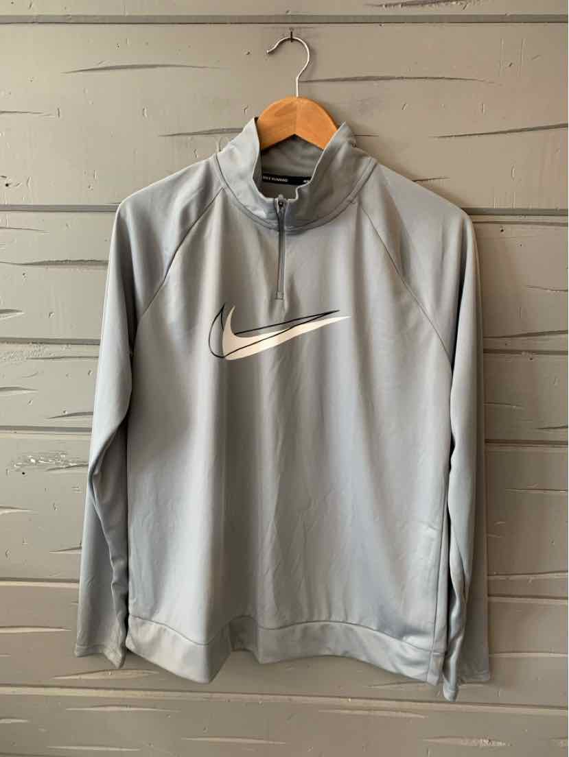 Light gray Nike long-sleeve pullover with white swoosh logo and quarter zip collar.