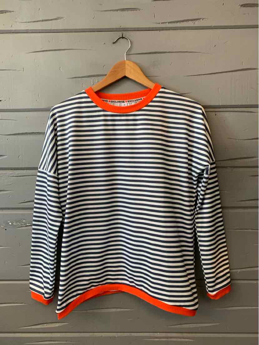 Women’s black-and-white striped long-sleeve top with bright orange trim at the neckline, cuffs, and hem.