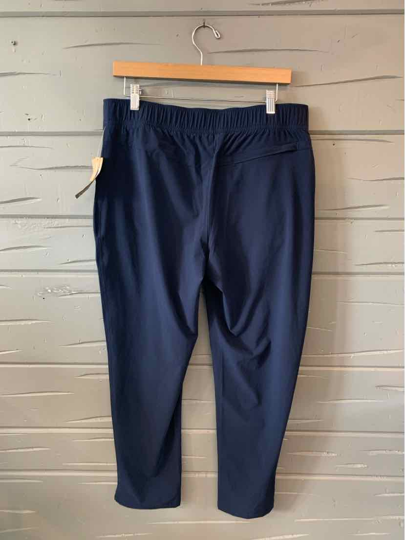 Navy blue casual pants with elastic waistband and straight-leg fit hanging on wooden hanger.