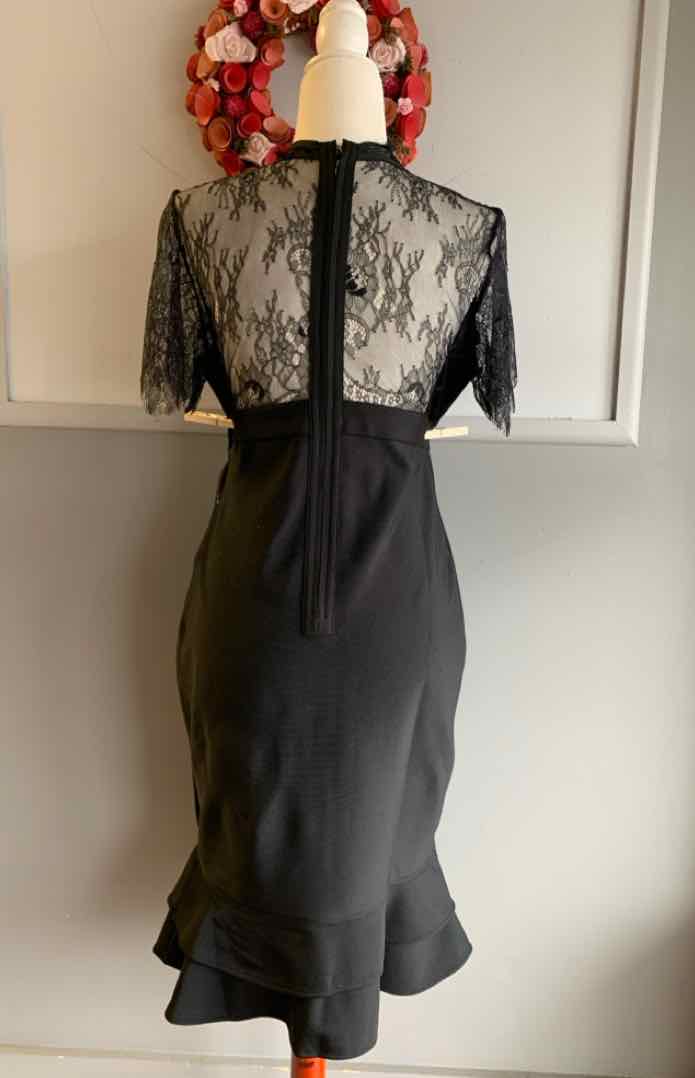 Black lace top dress with short sleeves and ruffled hem in large size, back view.