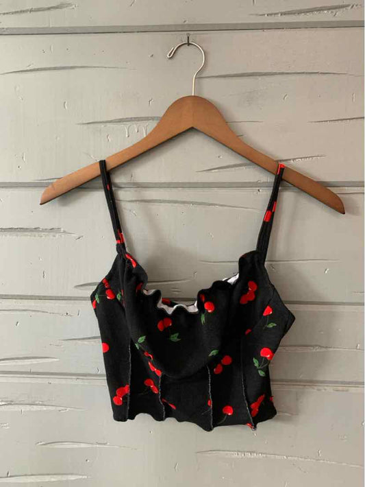Black cropped camisole with red cherry print and adjustable thin straps.