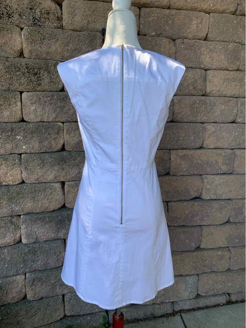 White sleeveless dress with fitted waist and exposed silver zipper down the back.