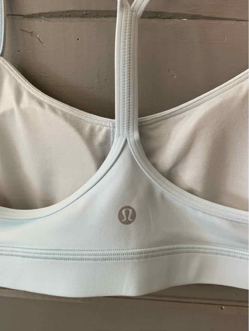 Light blue Lululemon sports bra with racerback design and subtle logo on elastic band.