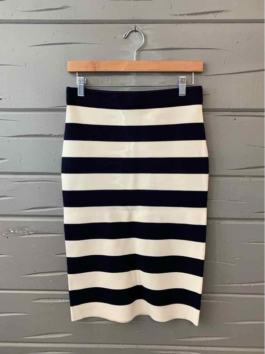 Black and white horizontal striped knee-length pencil skirt on wooden hanger.
