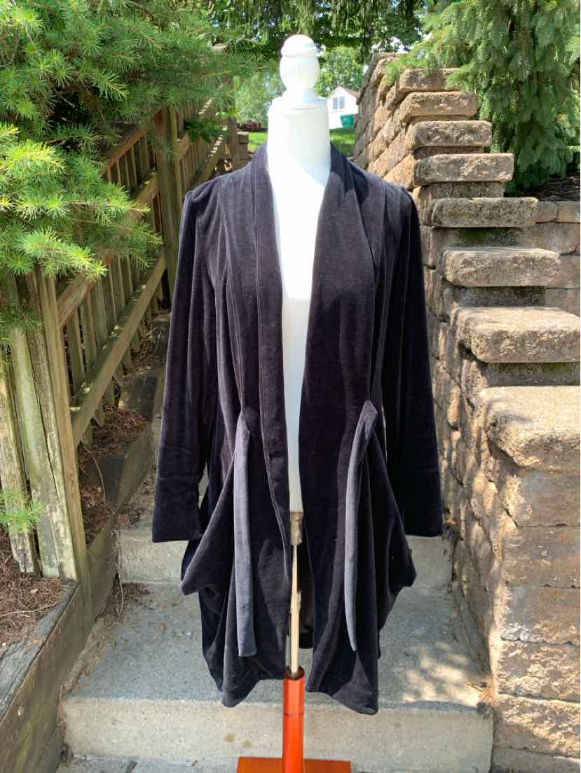 Black velvet open-front draped cardigan with long sleeves in XL size on mannequin outdoors.
